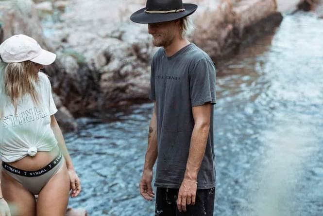 A young couple next to a waterhole in Litchfield